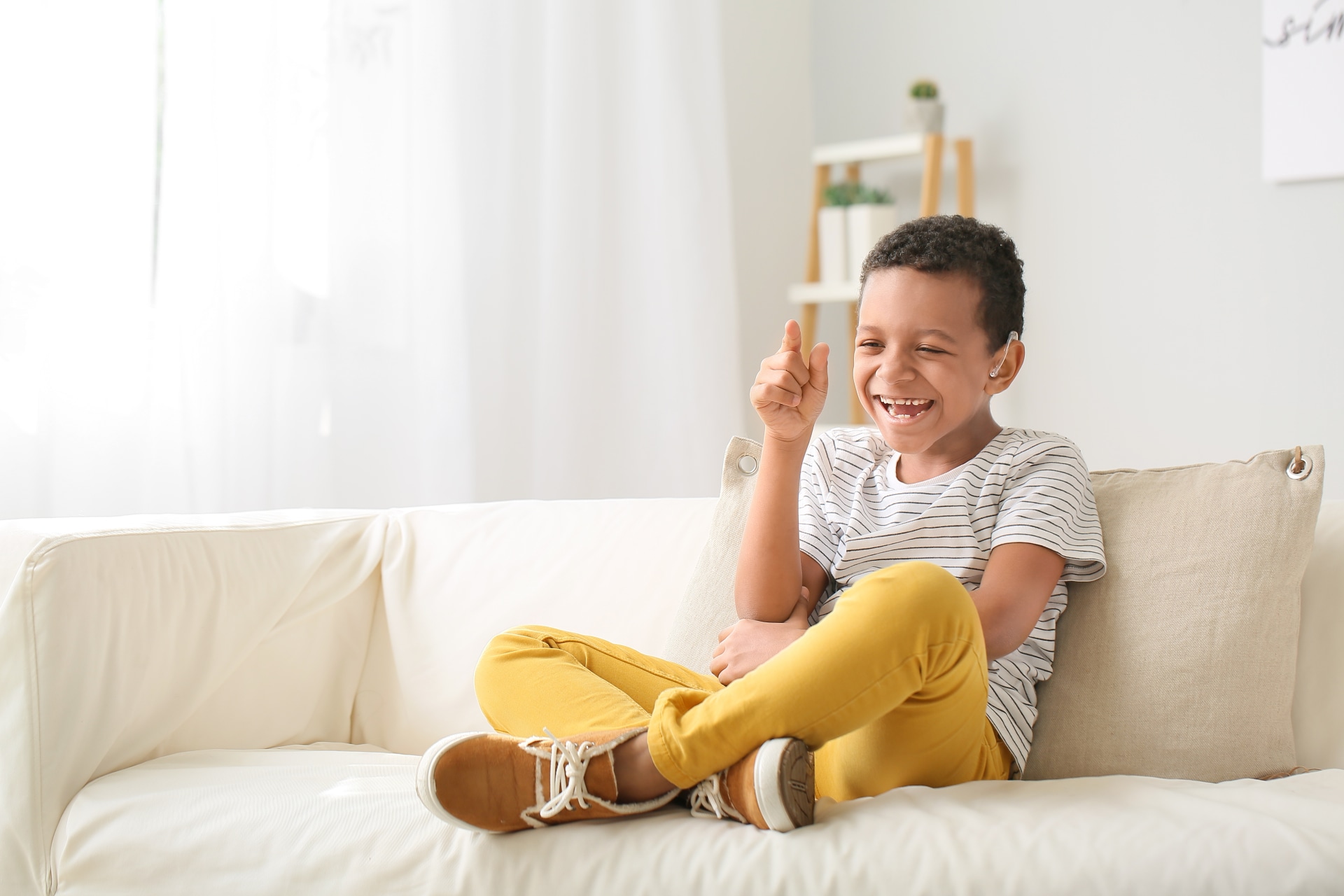 Boy with hearing device laughing