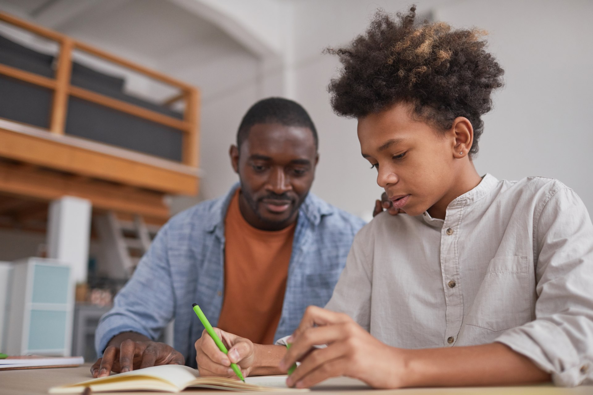 Father helping son working on homework