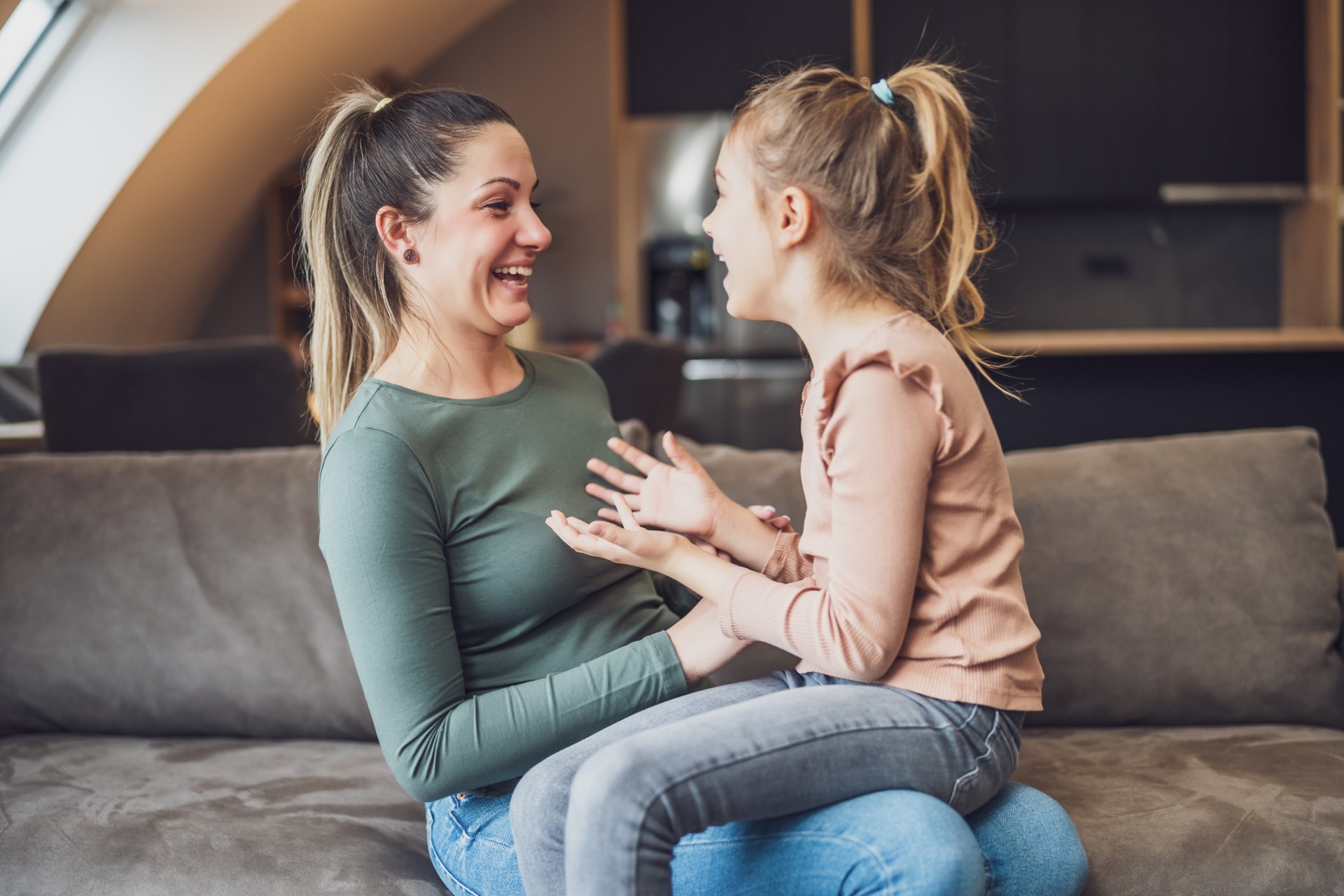 Happy mother and daughter enjoy spending time together at their home