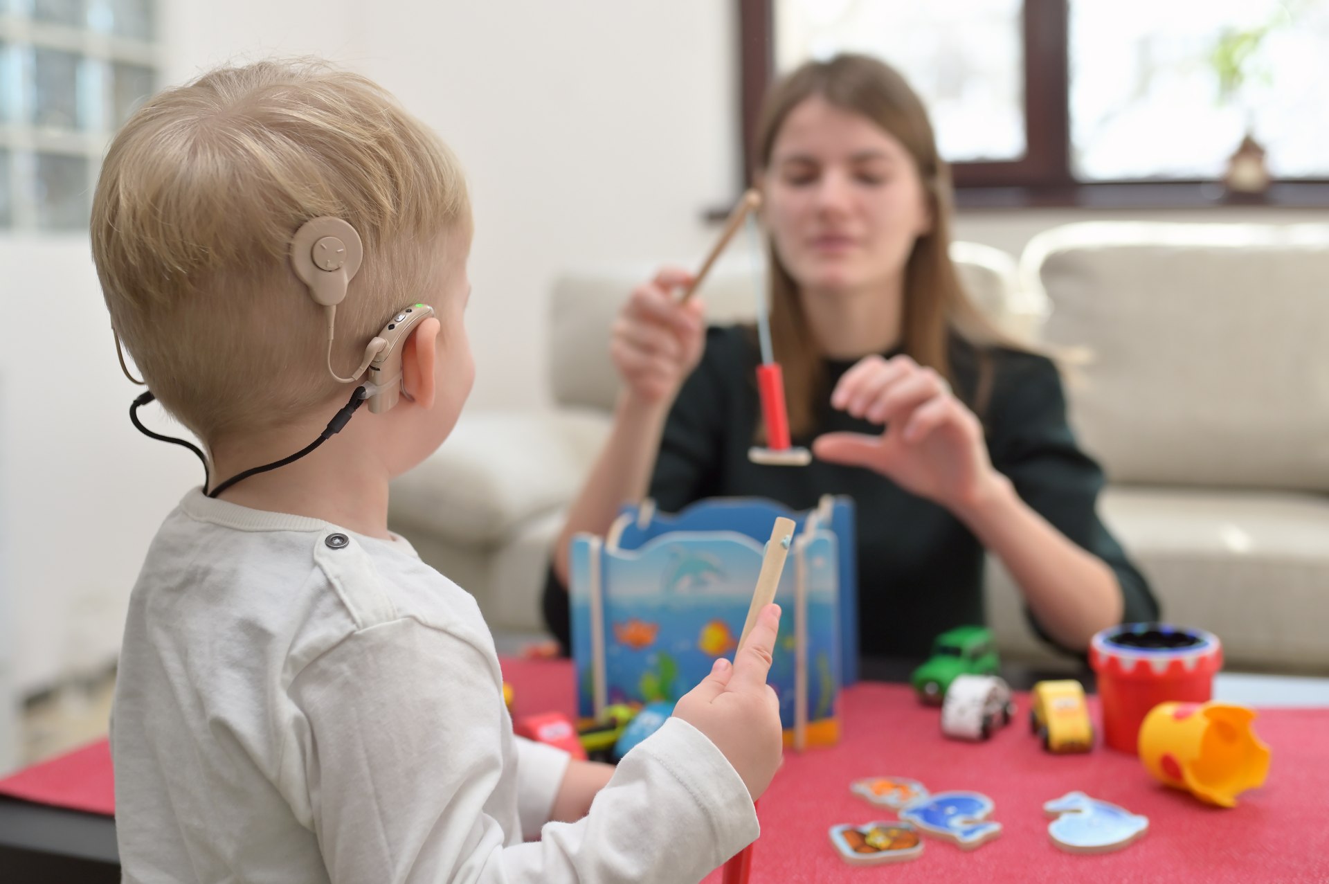 Child with hearing device playing