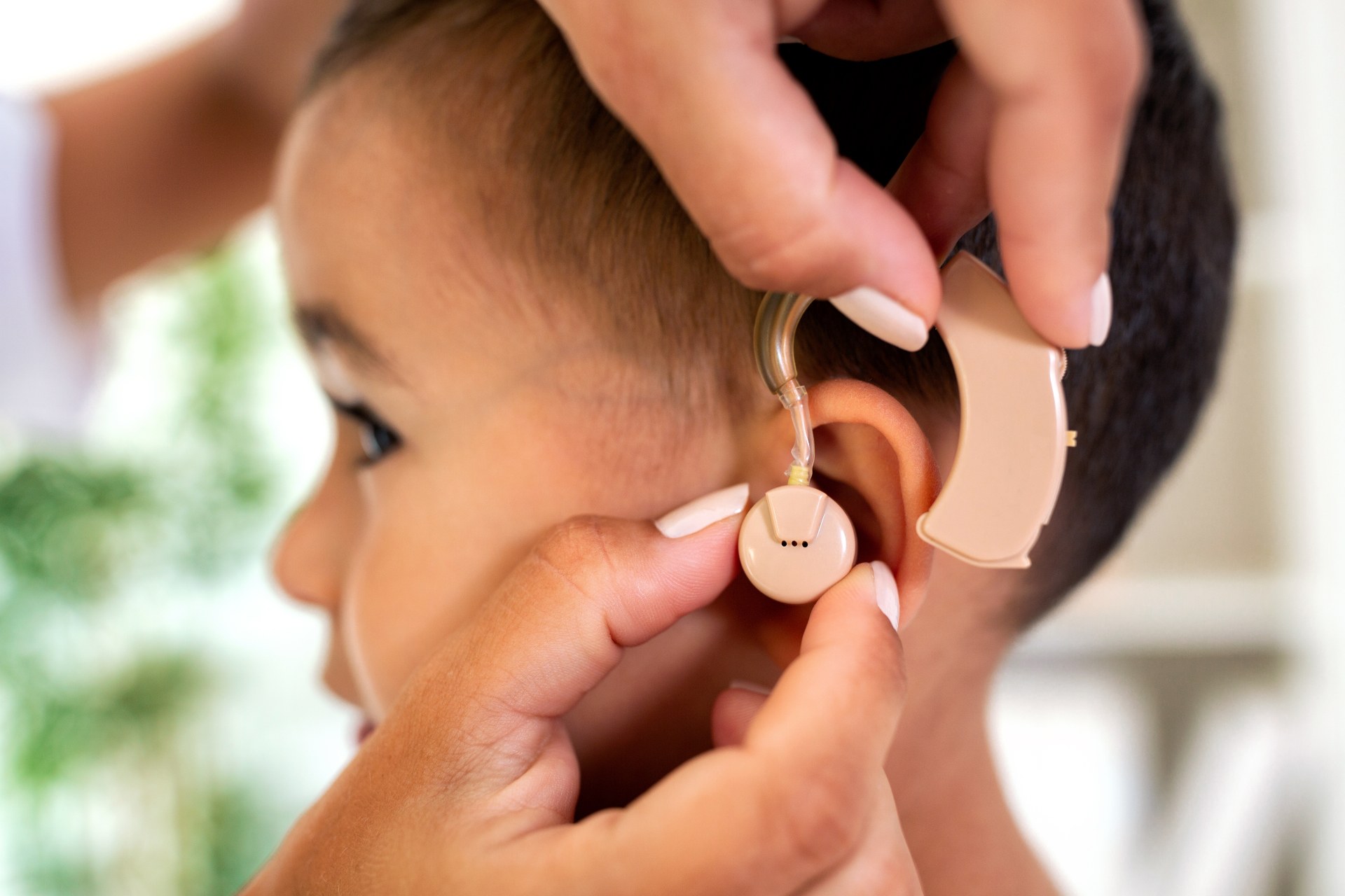 Young child getting hearing-aid