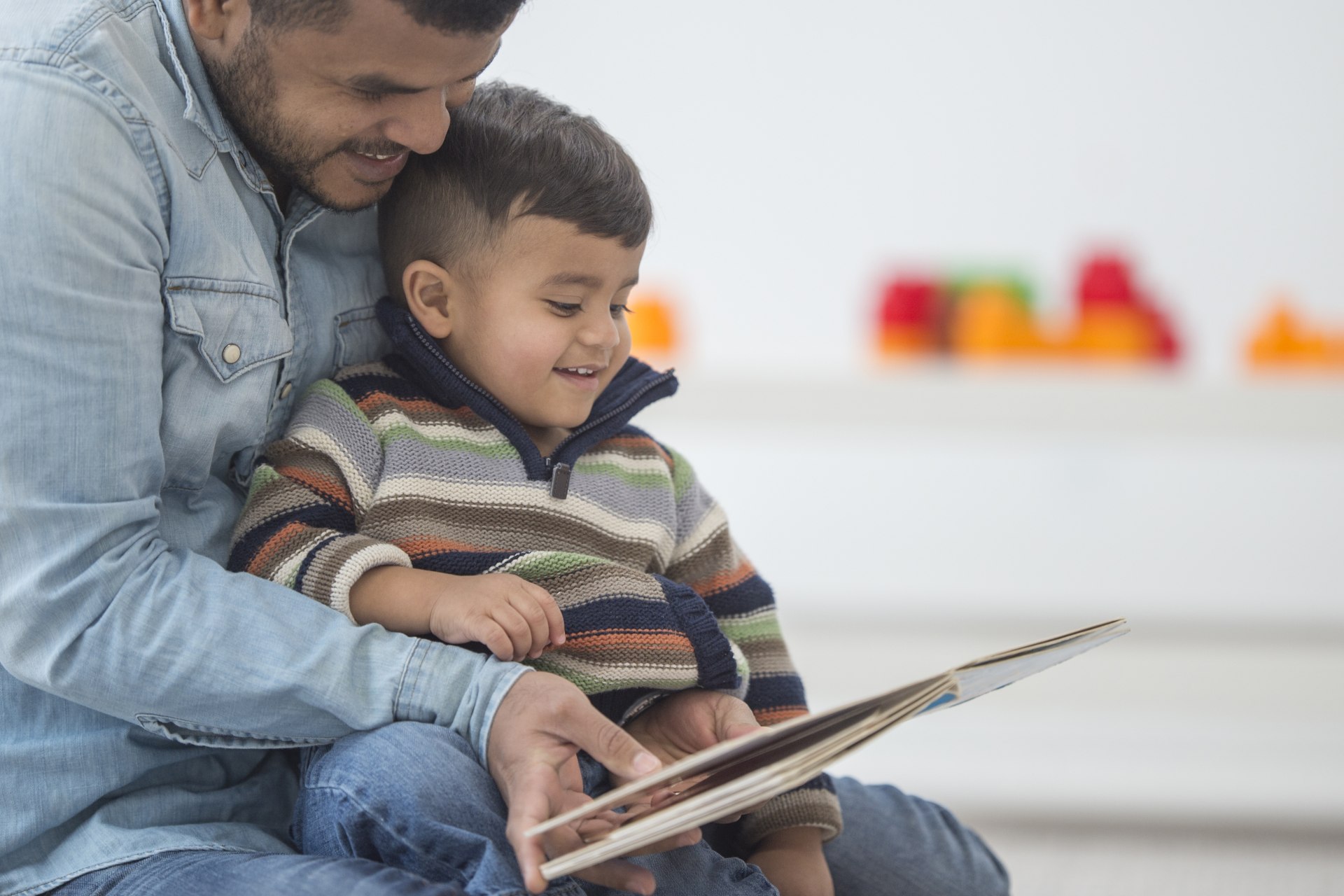 Man reading a book with his son