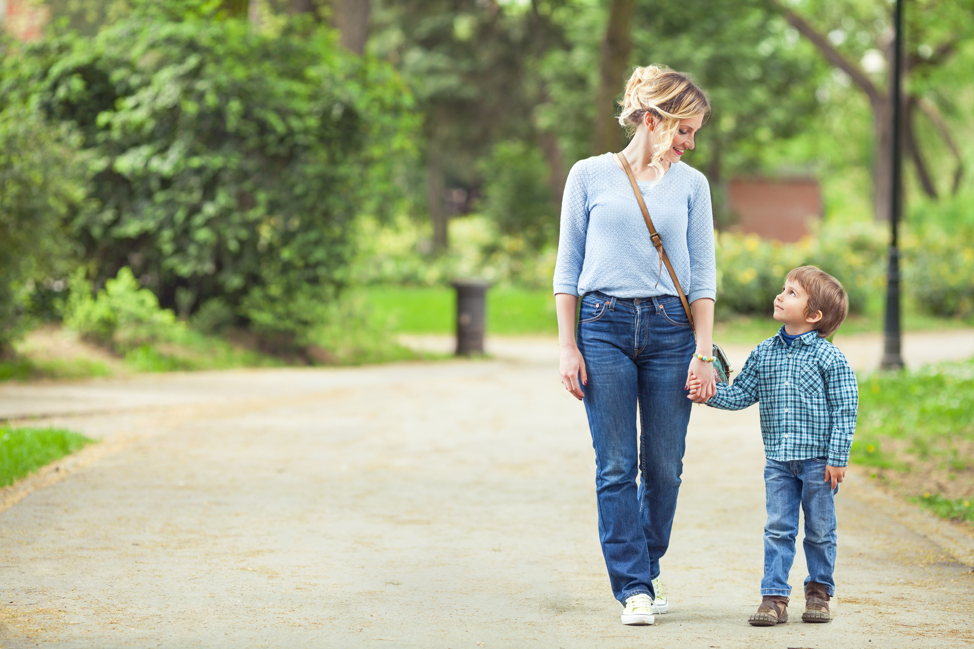 Mother walking with son on trail