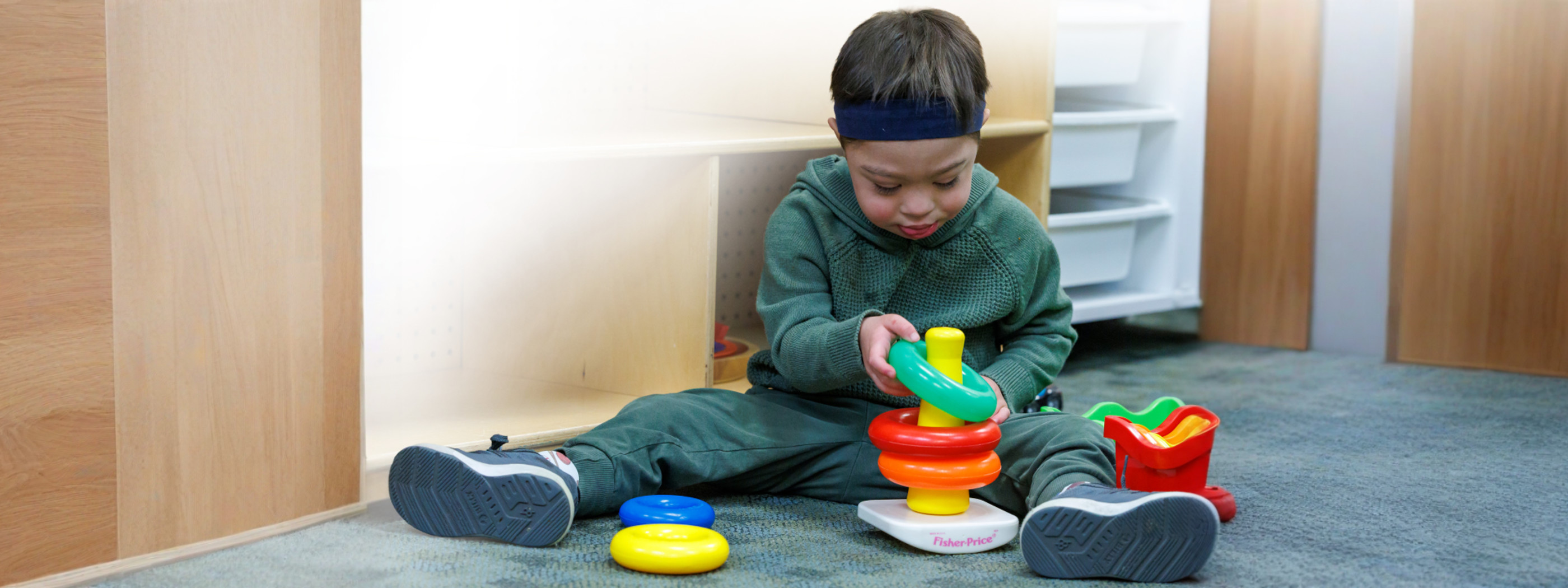 young boy stacking rings