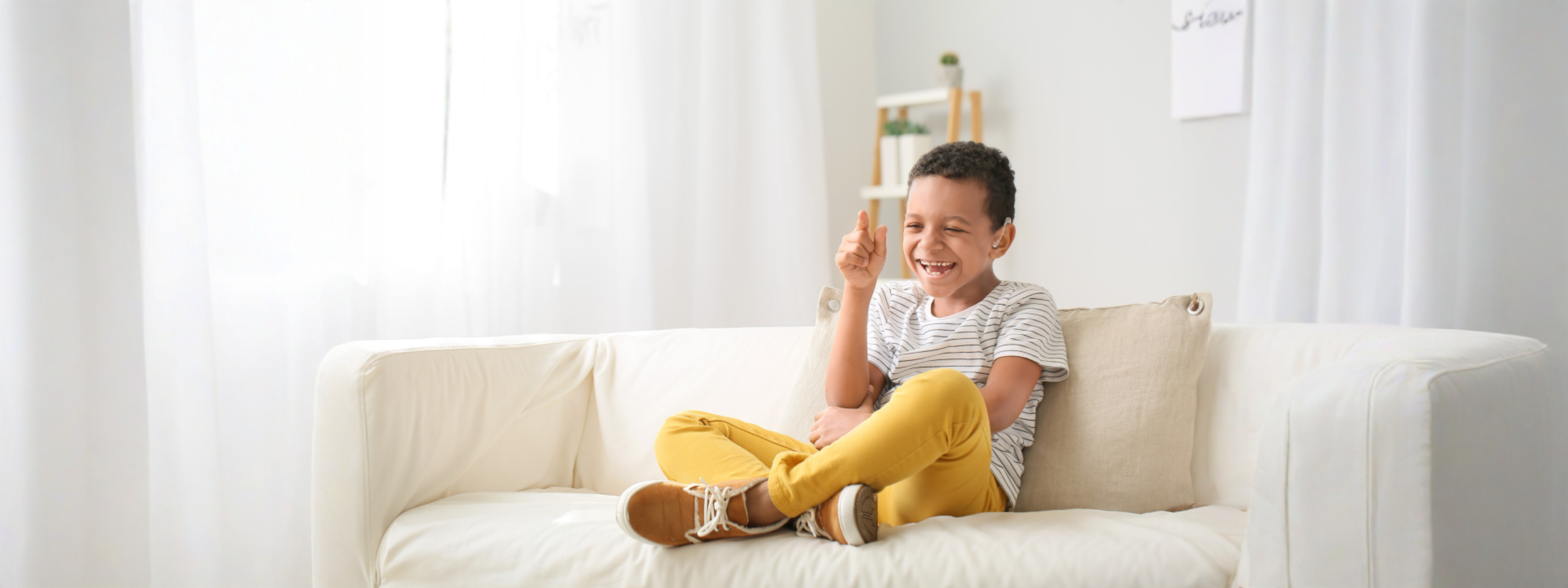 Boy with hearing device laughing