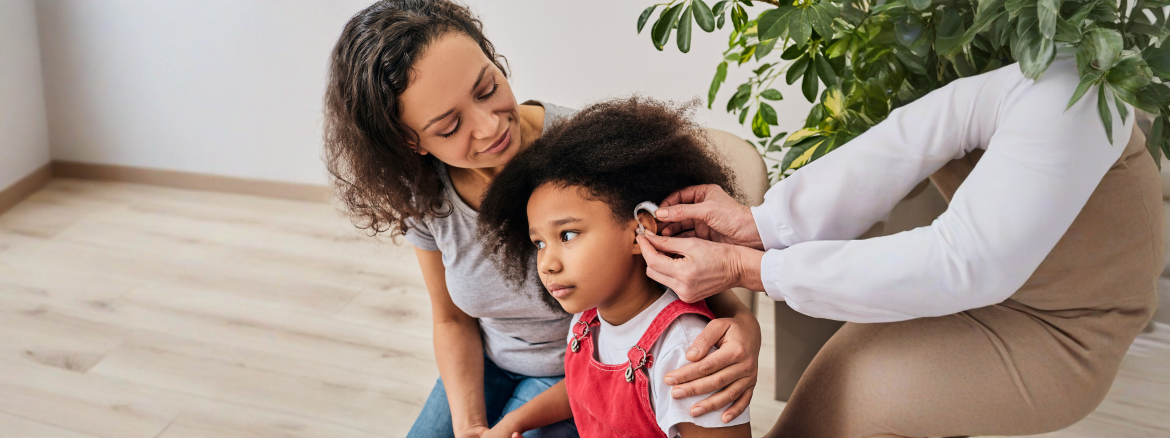 Mom with daughter getting hearing aid