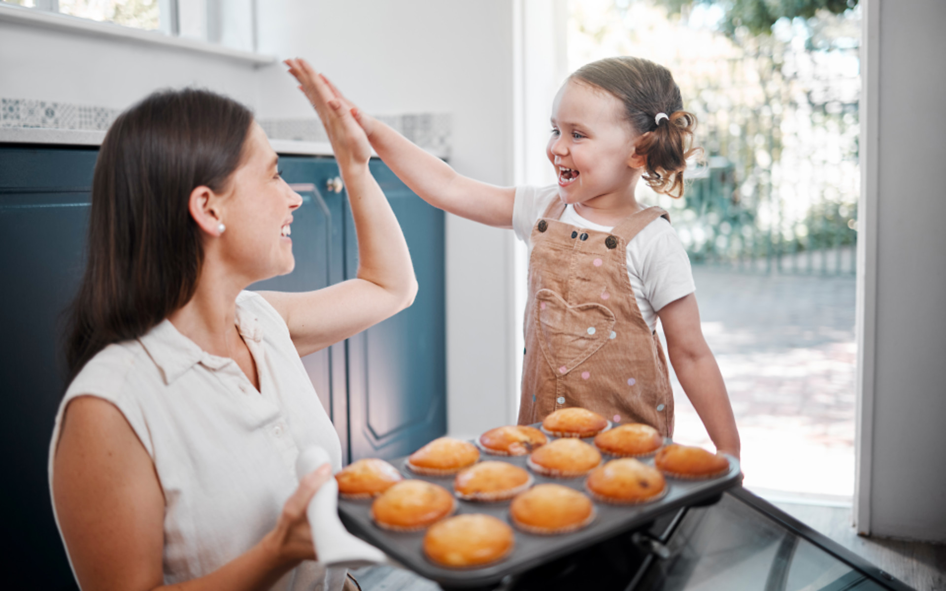 mom-high-fiving-daughter-baking