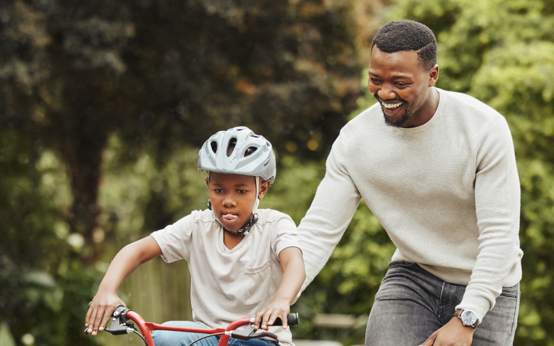 parent-teaching-child-to-ride-bike