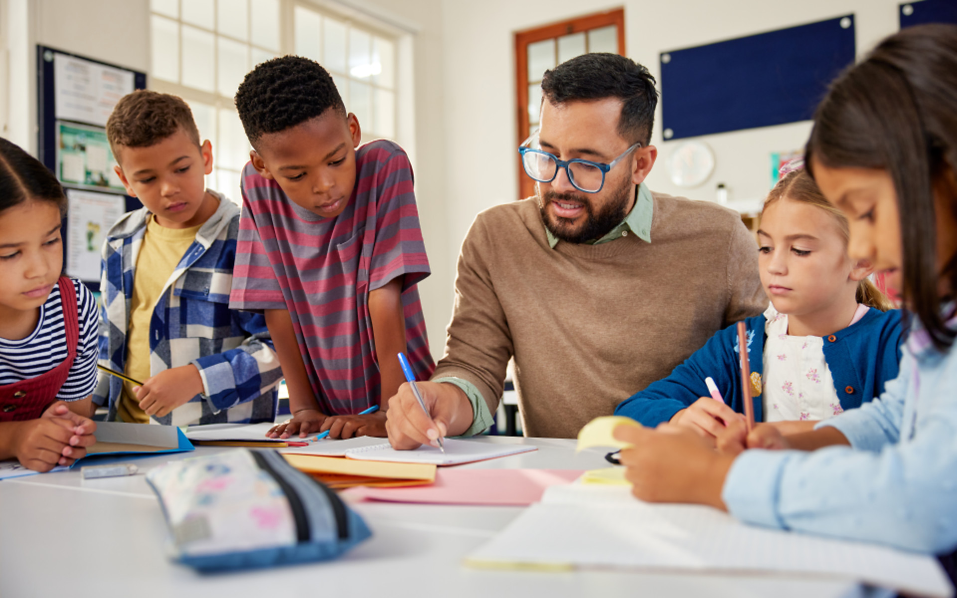 Teacher checking students' notebooks