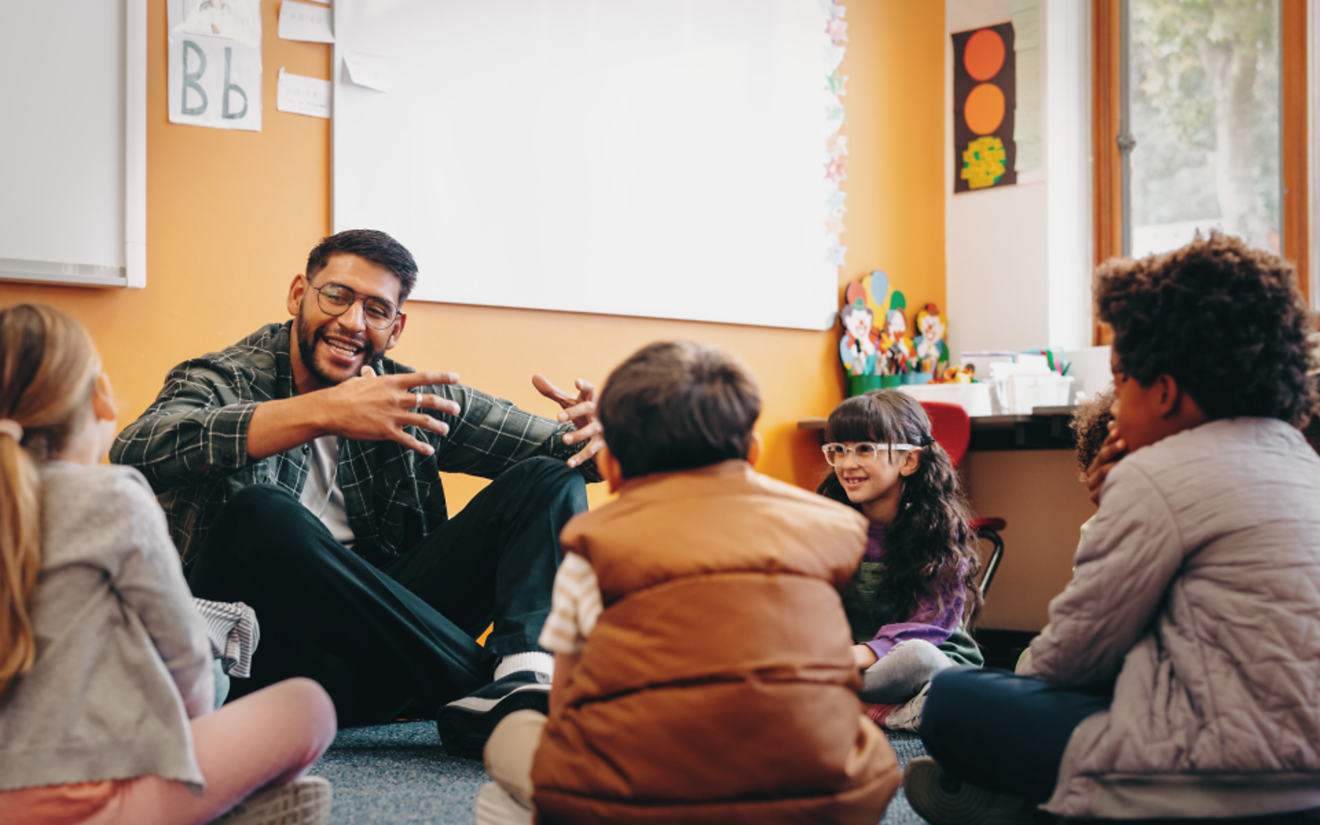 Teacher talking to his students in a classroom