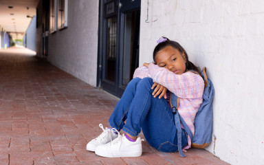 Sad girl against wall