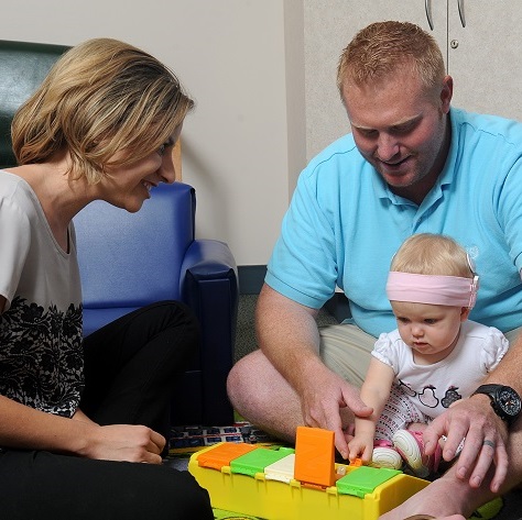 girl with cochlear implants playing with toys